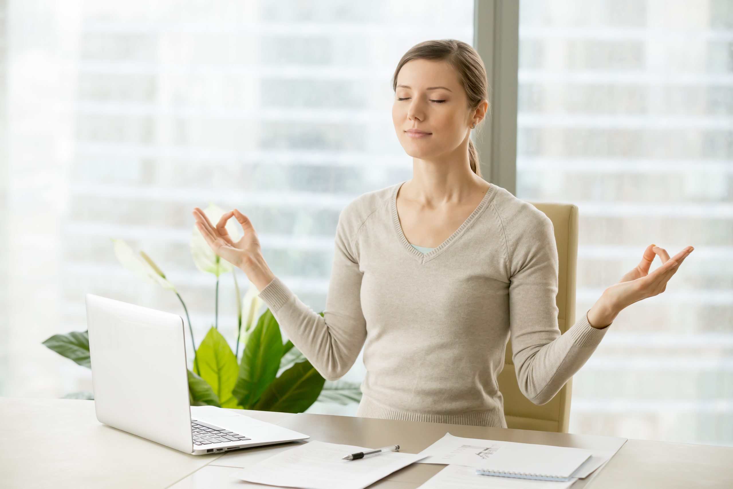 woman doing yoga in an office on the chair