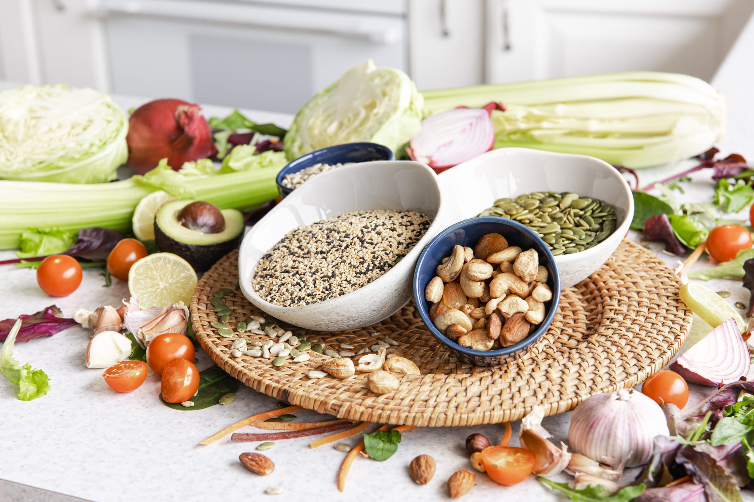 healthy foods, seeds, nuts, vegetables on a kitchen table - tomatoes, avocados, cabbage, garlic